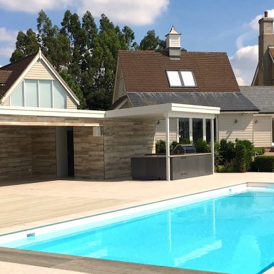 Rear view of swimming pool and pool house construction